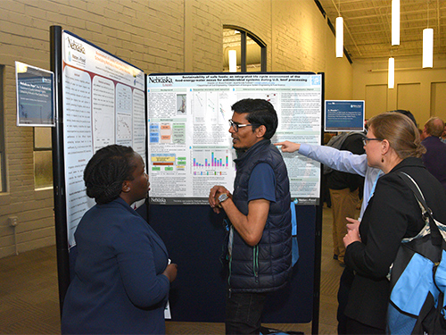 People talking in front of poster