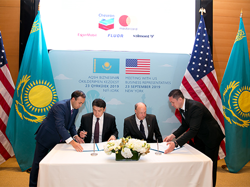 Two people at table signing documents