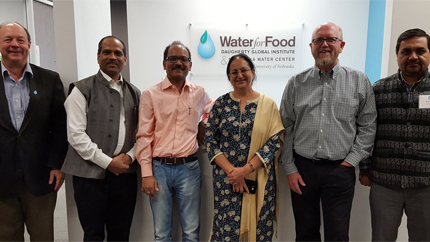 People standing in front of Water for Food logo