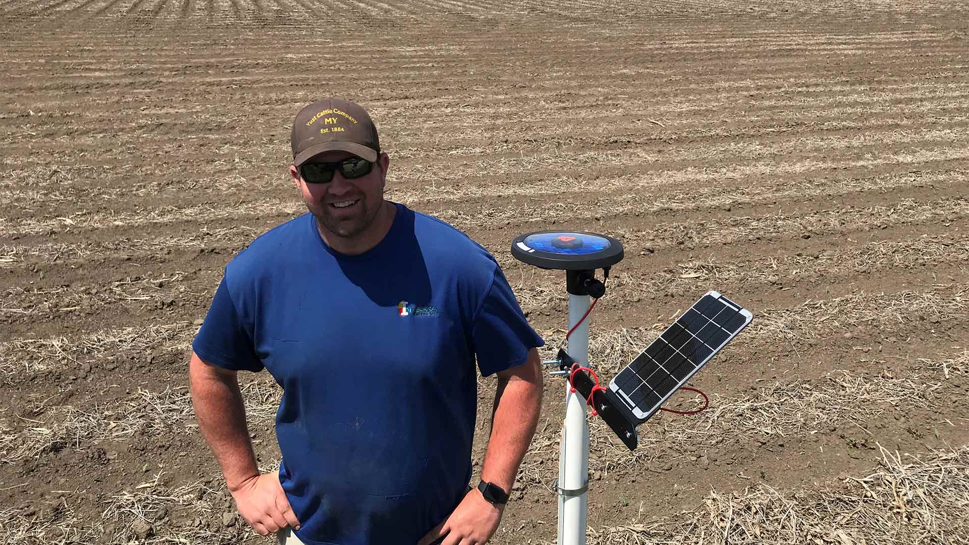 Person standing by instruments in front of field