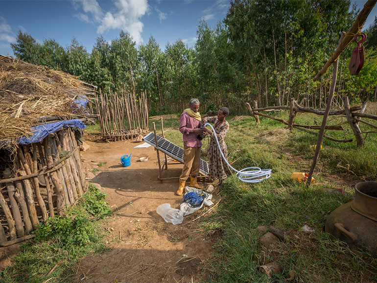 Smallholder farmers setting up irrigation system