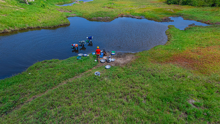 People on edge and in river