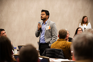 Chandra speaks to a audience in room