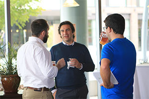 People having drinks and standing having discussion