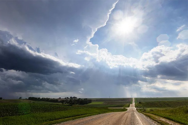 Country road with clouds on skyline