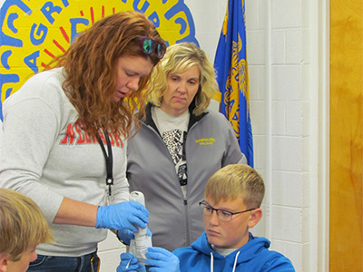 People working on scientific testing equipment