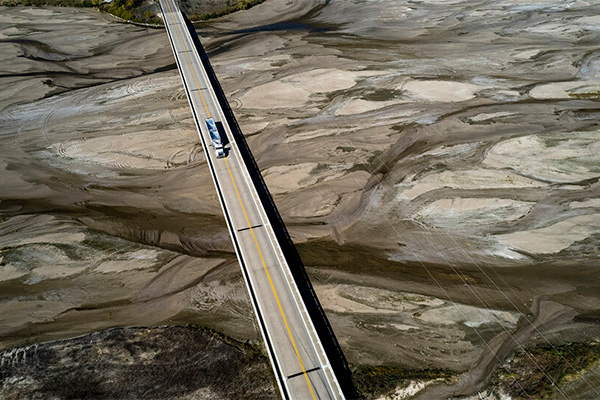 Vehicle driving on bridge over river