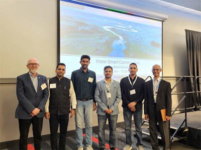 Group standing in front of presentation screen