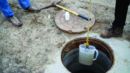 Extracting water sample from manhole