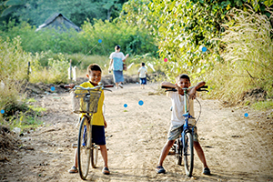 Two children riding bicycles