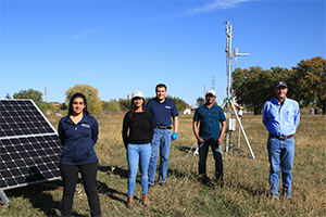 Group of researching in field in front of scientific equipment