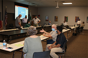 Small groups of people discussing ideas in room