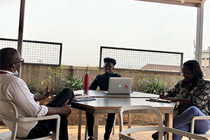 Three people sitting at desk having discussion