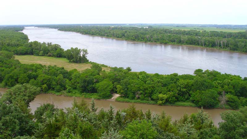 Looking over large river with trees on banks