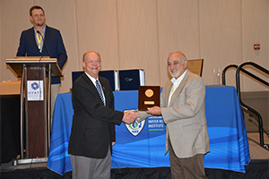 Person shaking hand and receiving award