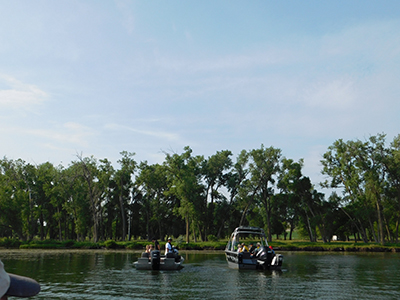 People in river on boats