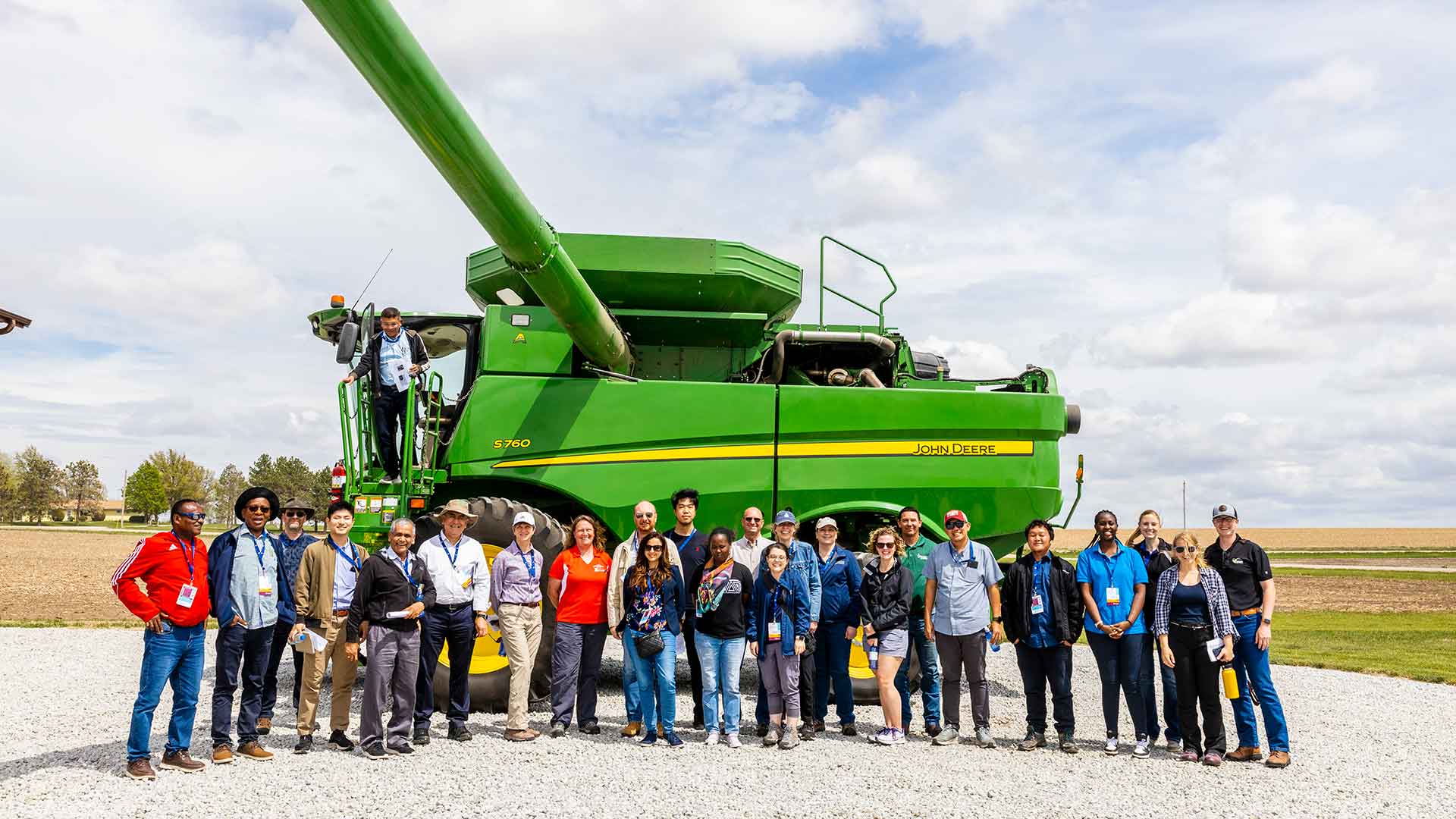 Group photo in front of agriculture combine