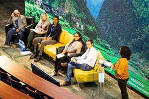 Conference speakers sitting on stage