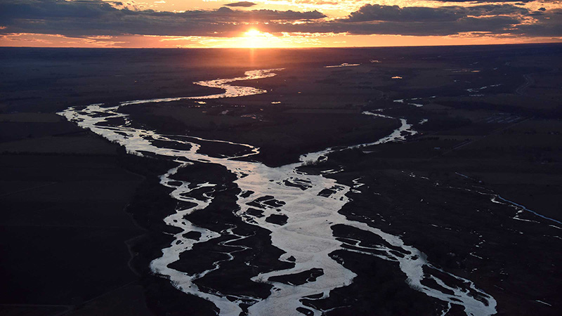 Sunset over aerial view of river