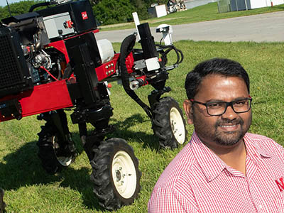 Person standing in front of agriculture equipment