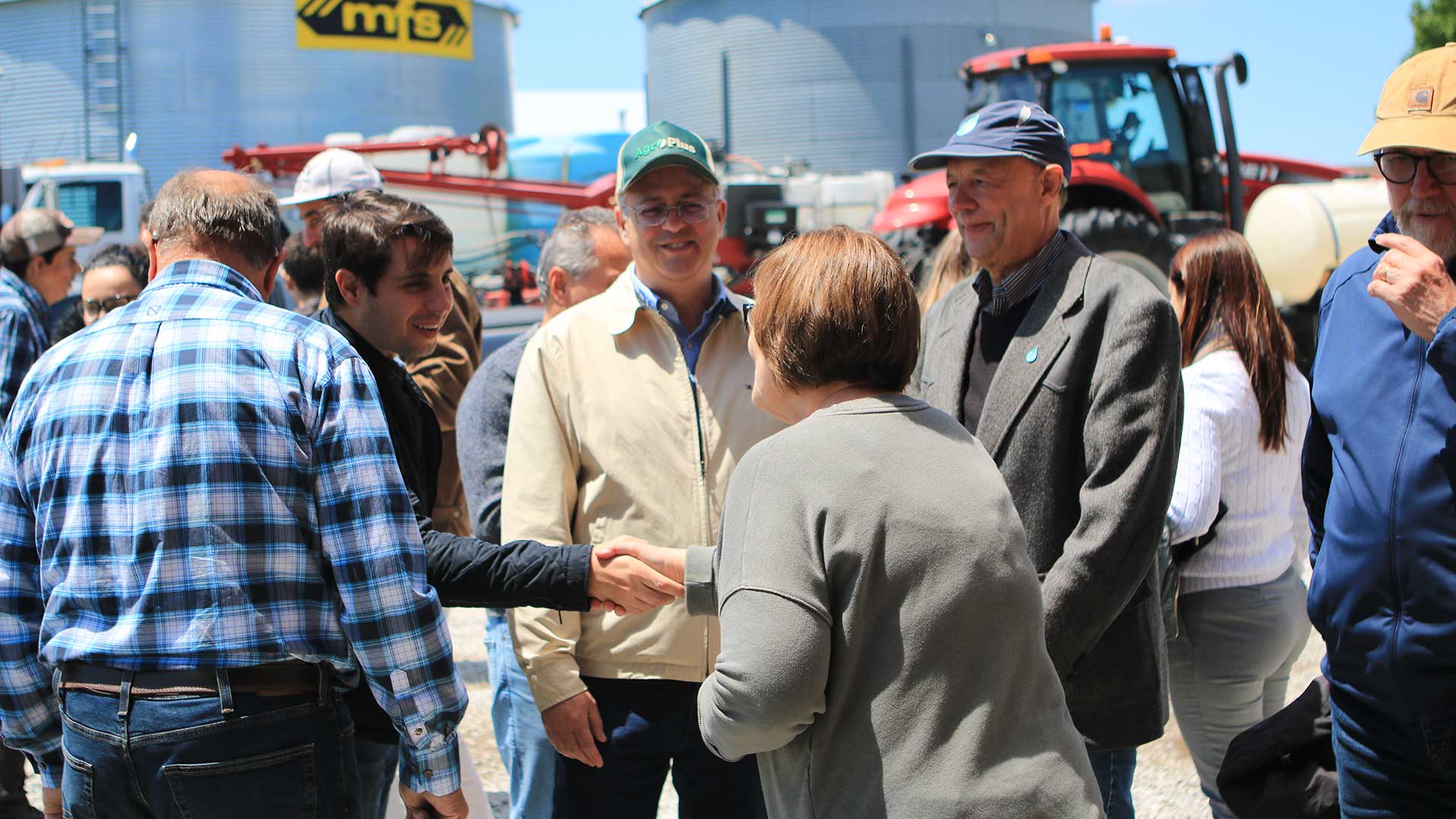 Two people shaking hands within group