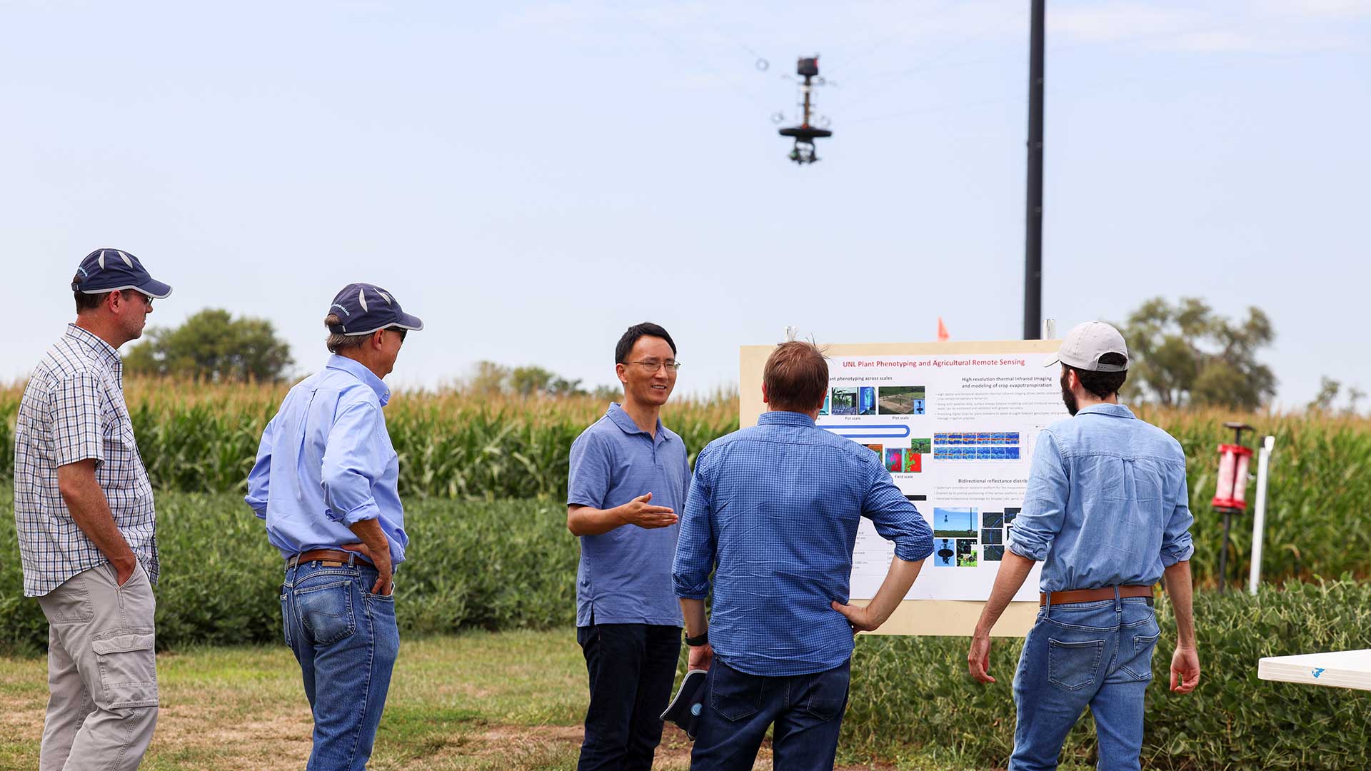 Small group standing in front of field