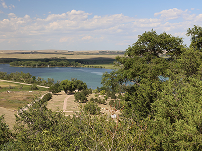 Landscape view of river in background and tree in foreground 