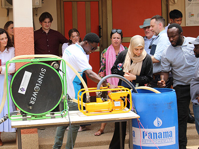 Group observing irrigation equipment on display