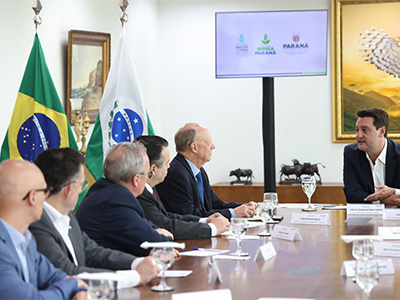 People sitting at table looking at person speaking