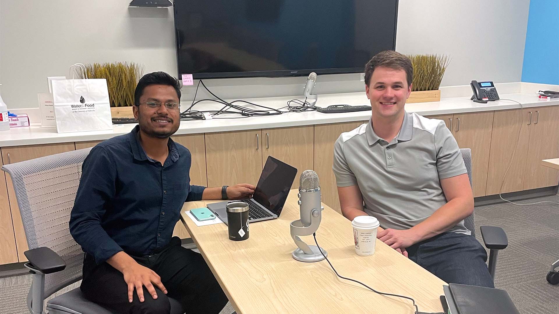 Podcasters sitting at desk