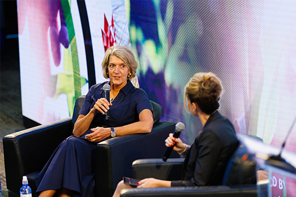 Two people talking on stage