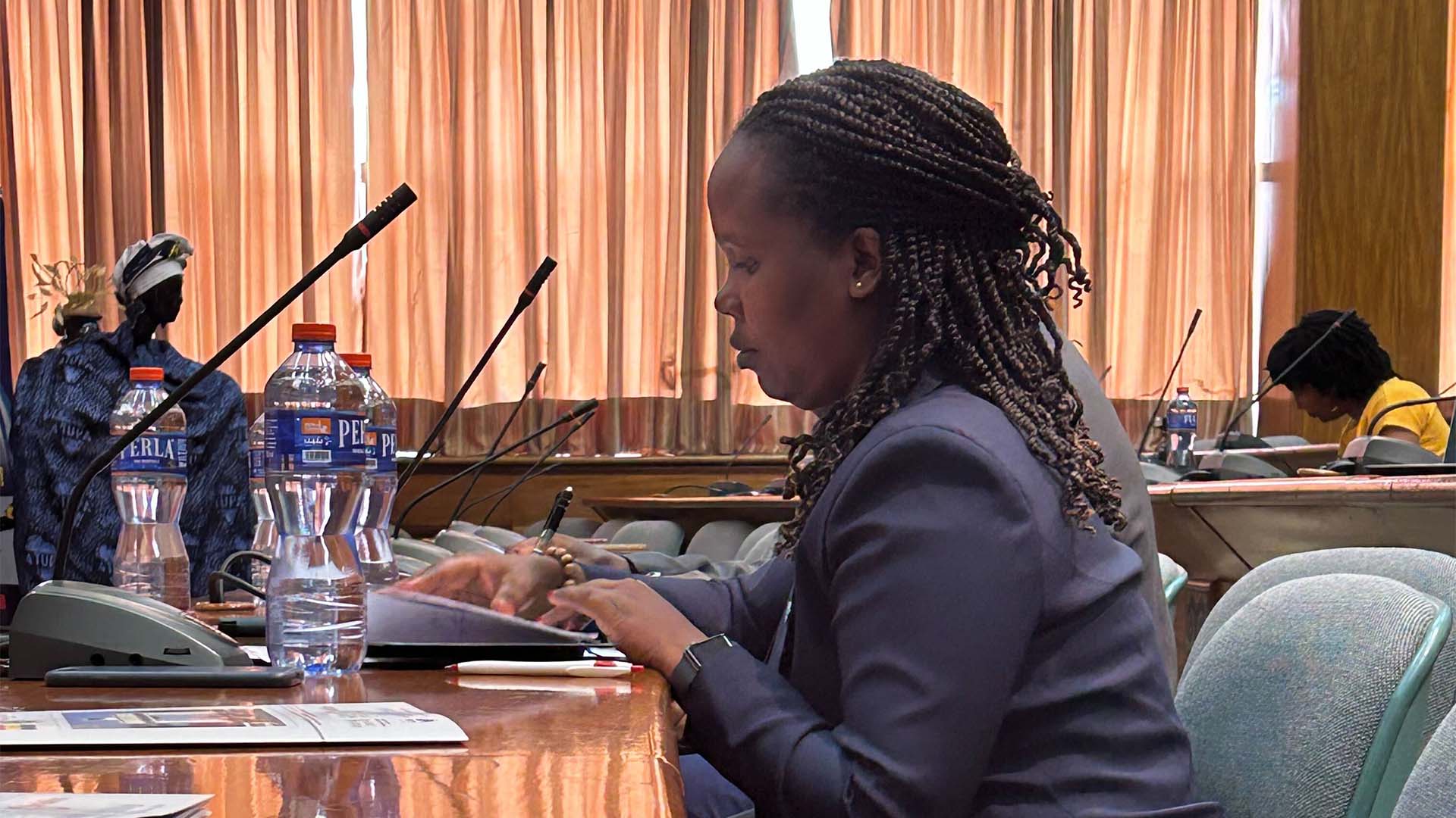 Person sitting at desk with microphones