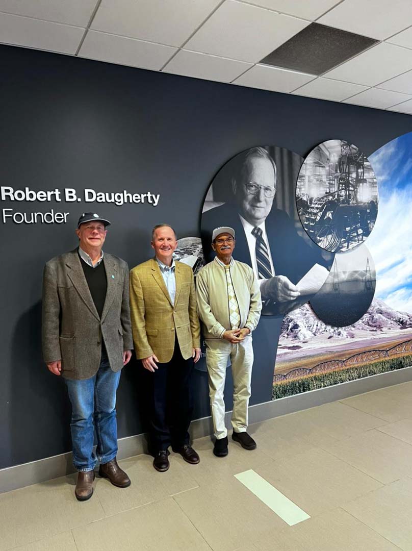Three people standing by wall