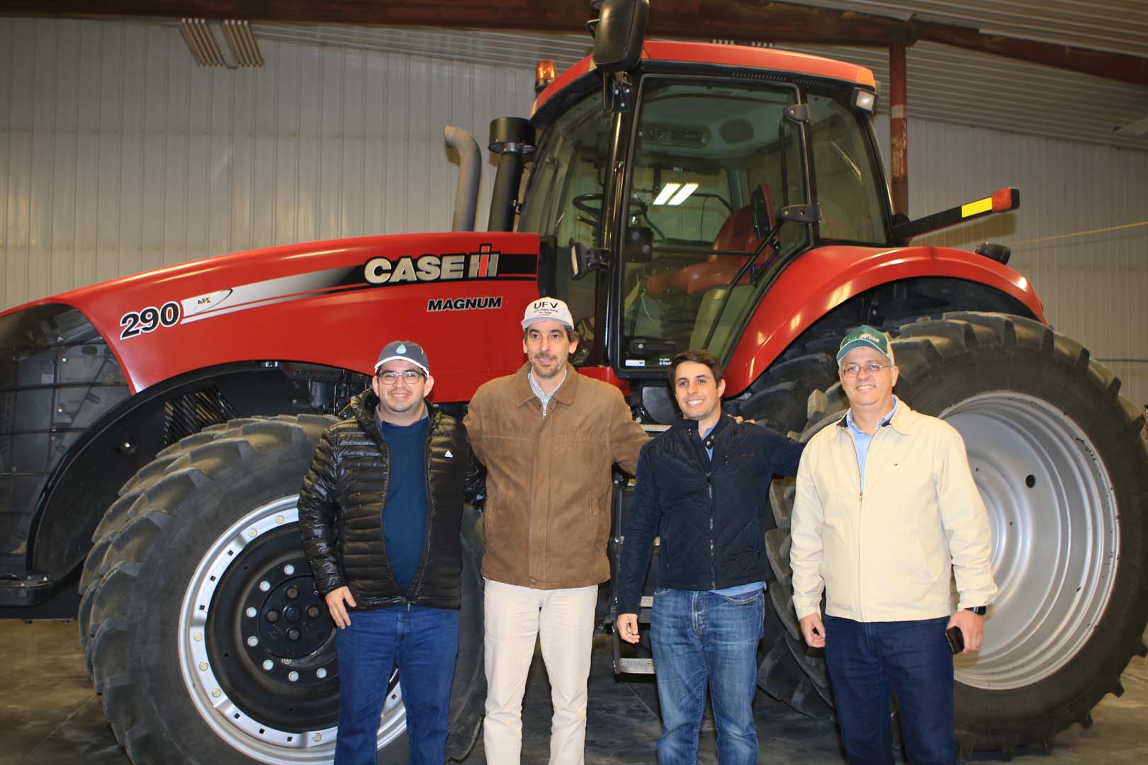 People standing in front of large tractor
