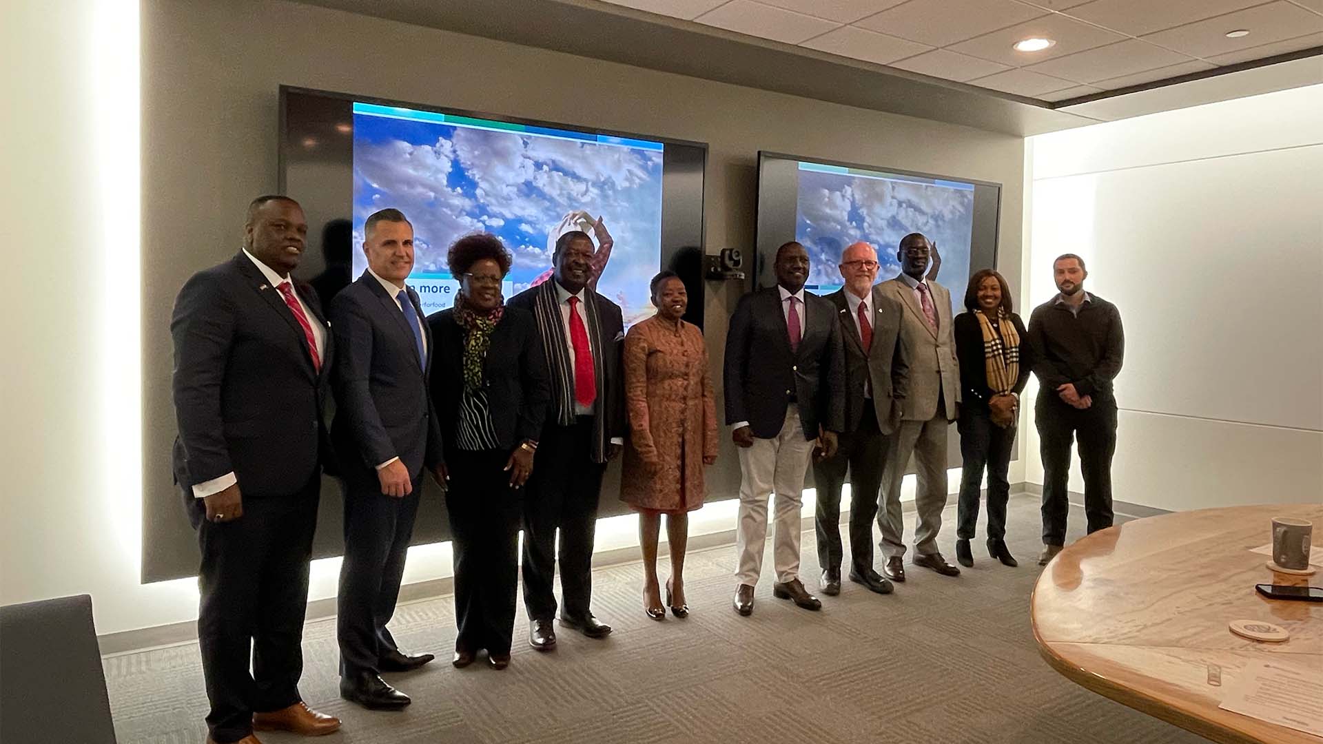 Large group standing in front of wall