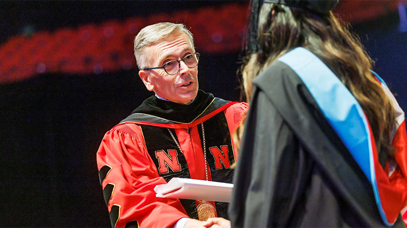 Person at graduation shaking hands with another person