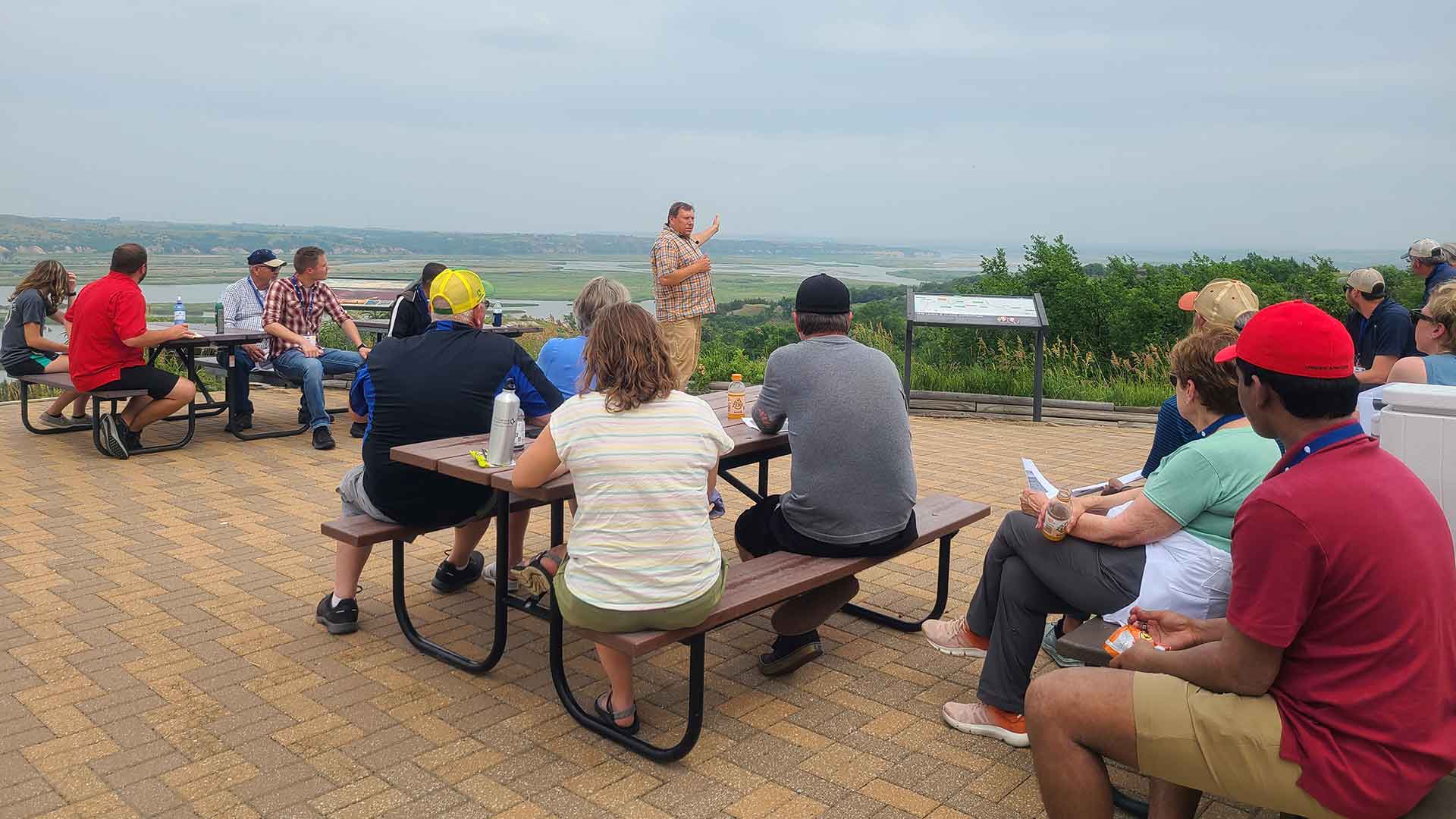 Groups sitting at tables outdoors