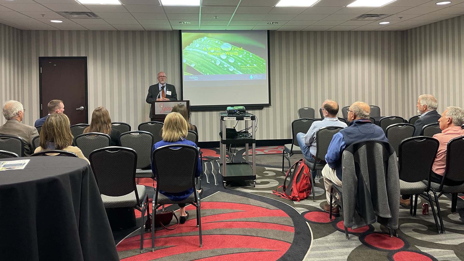 People sitting in room listening to presenter