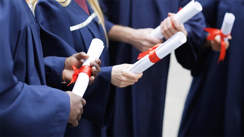 People holding dipolmas