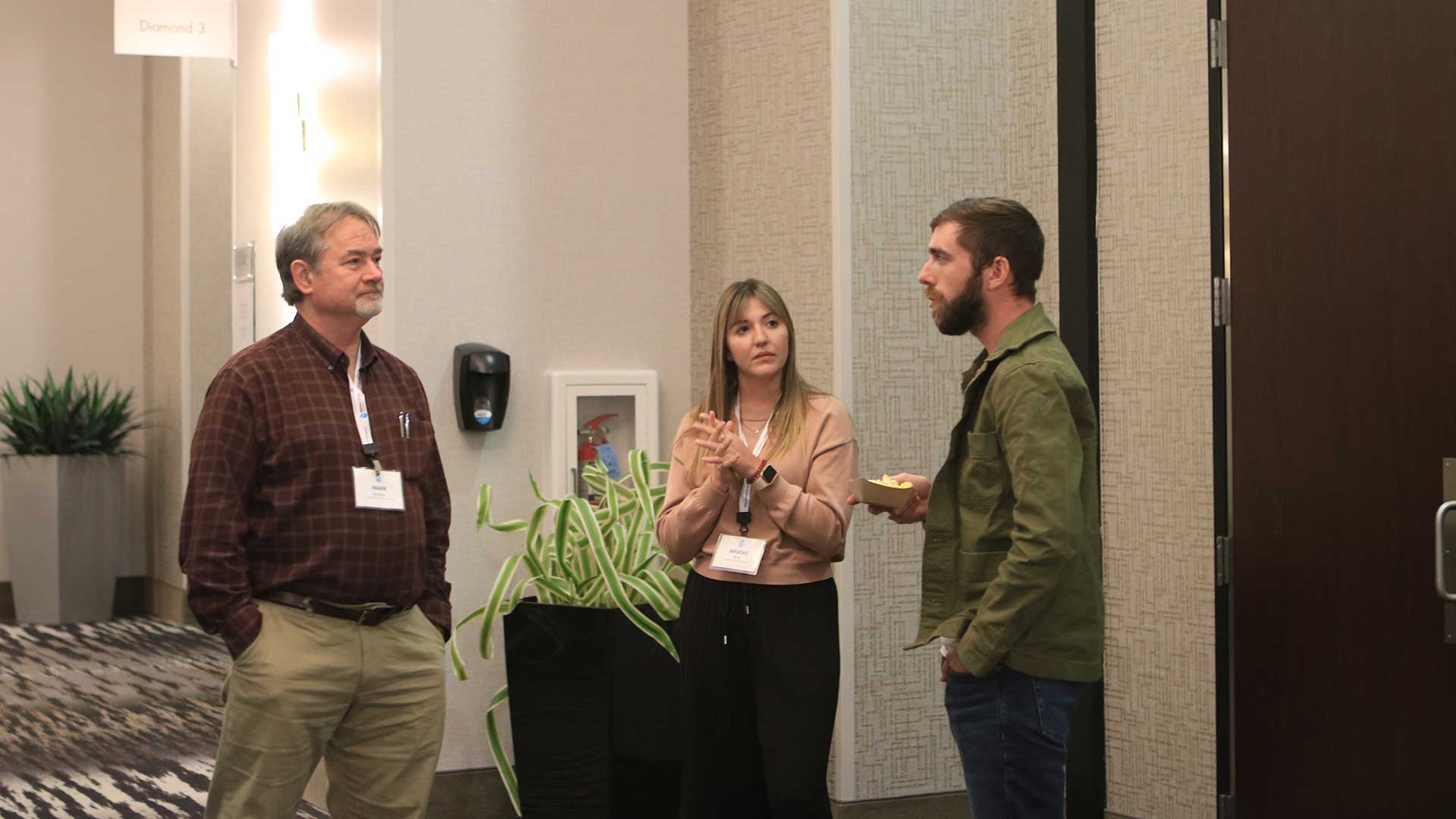 Three people having a group conversation