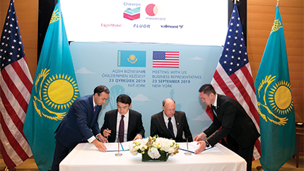 People sitting at table signing documents